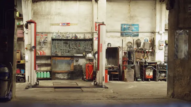 Vehicle workshop with tools and service equipment; contextual photo, not a compared battery charger.