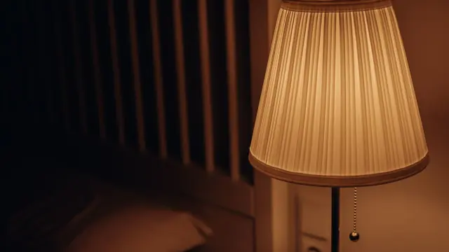 Warm table lamp in a room; contextual photo, not a compared smart plug.