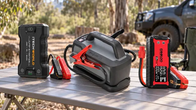 AI-generated illustration of three unplugged jump starters on a camp table beside a parked vehicle; not connection instructions.